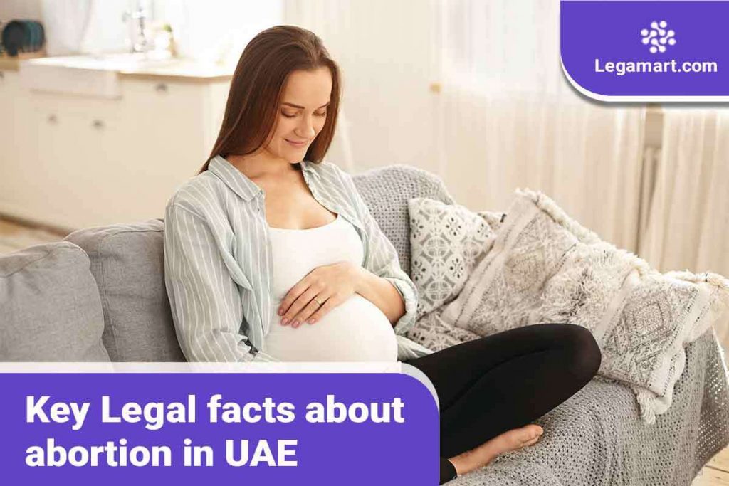 A pregnant woman reading about abortion in UAE