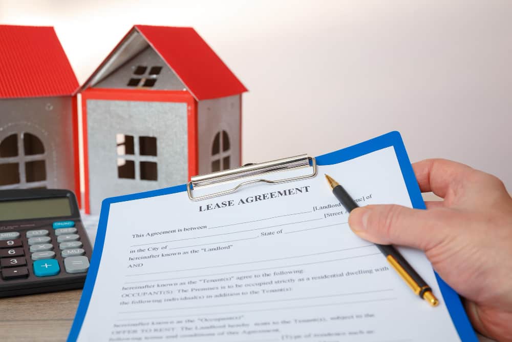 A lawyer finalizing the Lease vs Rent for a house owner